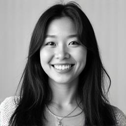 Professional black and white headshot of Sara Khairul, a professional woman with a welcoming smile.